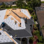 Professional roofing crew installing new shingles and underlayment on a Florida home in the Tampa Bay area