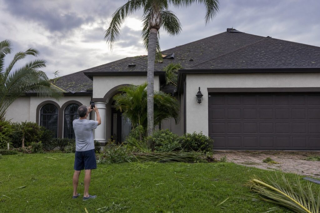 Tampa Bay Florida home with storm damage being inspected by homeowner after hurricane season weather event