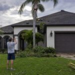 Tampa Bay Florida home with storm damage being inspected by homeowner after hurricane season weather event