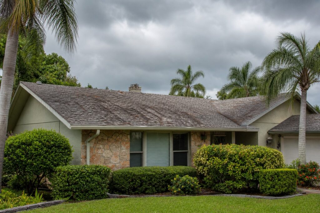 Aging asphalt shingle roof on a Florida home in the Brandon Tampa Bay area before hurricane season