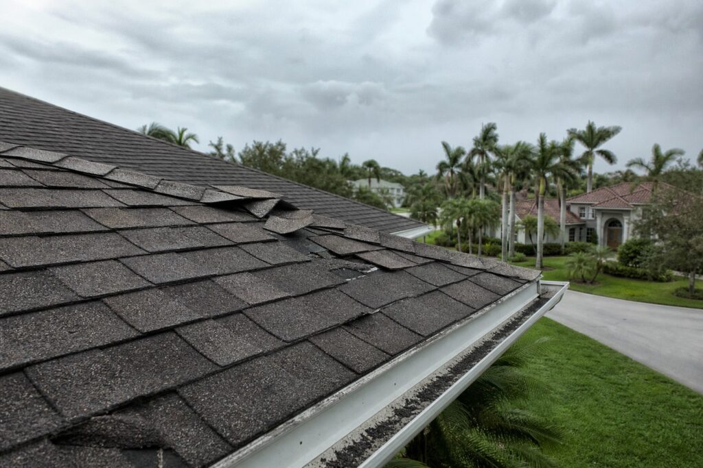Weathered roof on a Brandon, Florida home showing storm damage from lifted shingles and granule loss — a common sight in Hillsborough County after Hurricane Milton