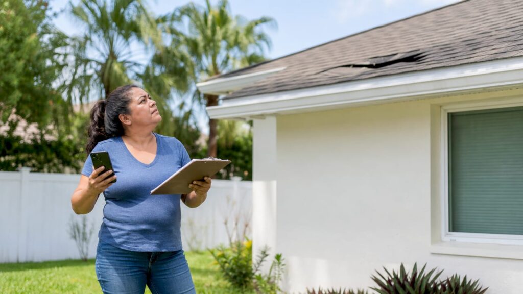 Florida homeowner inspecting roof storm damage