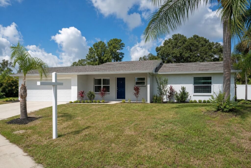 Recently renovated Florida ranch home for sale in Tampa Bay neighborhood with older roof and fresh landscaping