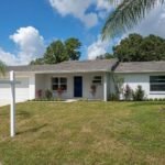 Recently renovated Florida ranch home for sale in Tampa Bay neighborhood with older roof and fresh landscaping