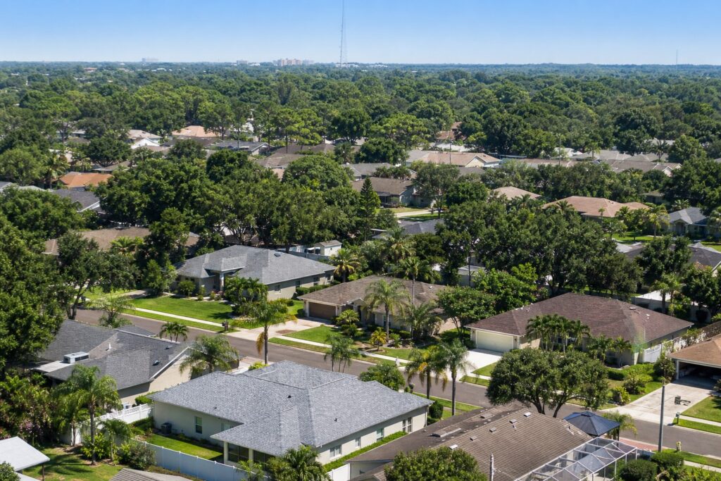 Inland Tampa Bay suburban neighborhood rooftops absorbing intense summer heat, illustrating the urban heat island effect in Hillsborough County