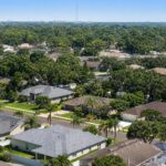 Inland Tampa Bay suburban neighborhood rooftops absorbing intense summer heat, illustrating the urban heat island effect in Hillsborough County