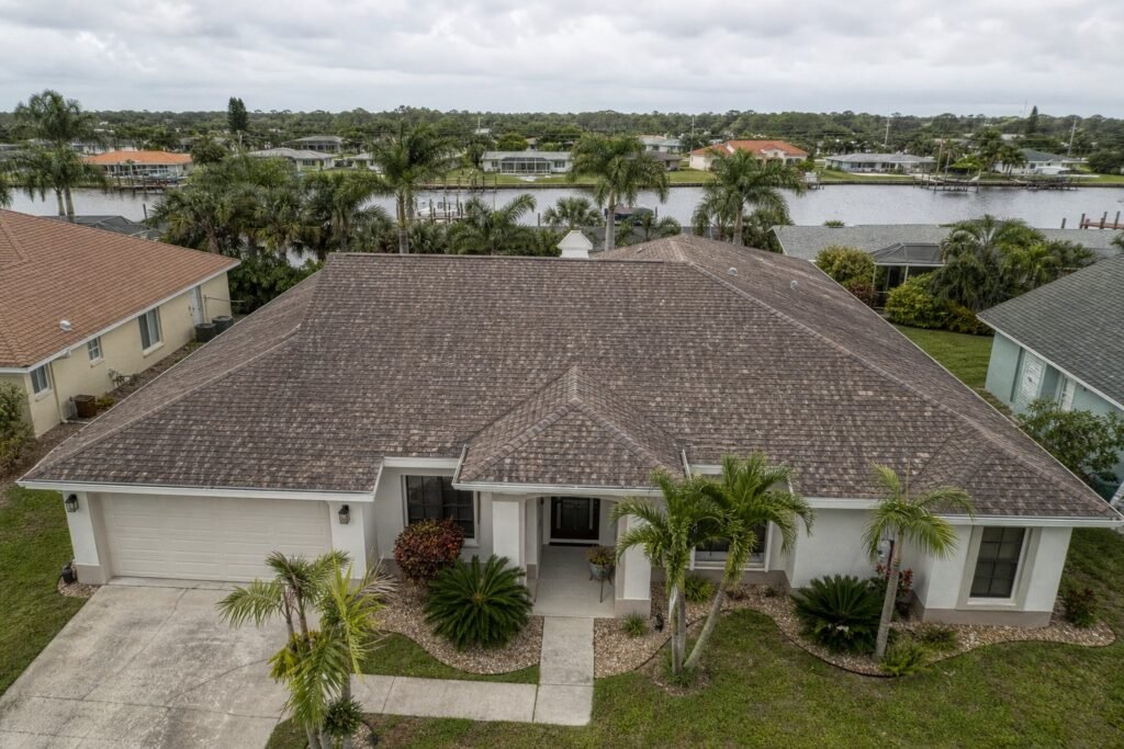 Aging asphalt shingle roof on a Tampa Bay Florida home showing granule loss and wear in humid subtropical climate