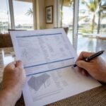 Homeowner reviewing a detailed roofing estimate document at a kitchen table in a Tampa Bay Florida home