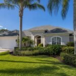 Tampa Bay Florida home with new architectural shingle roof in a residential neighborhood with palm trees